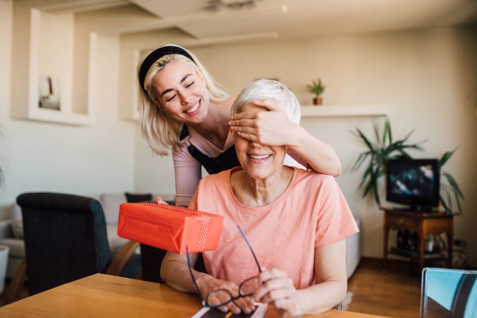 Mother receiving Mother's Day gift.