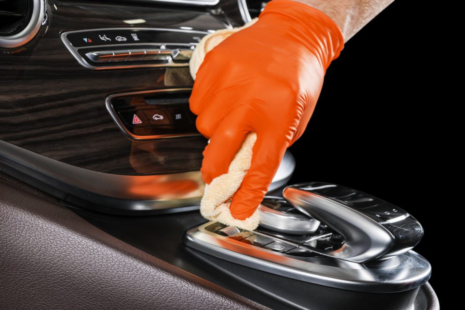 A man cleaning car with microfiber cloth.