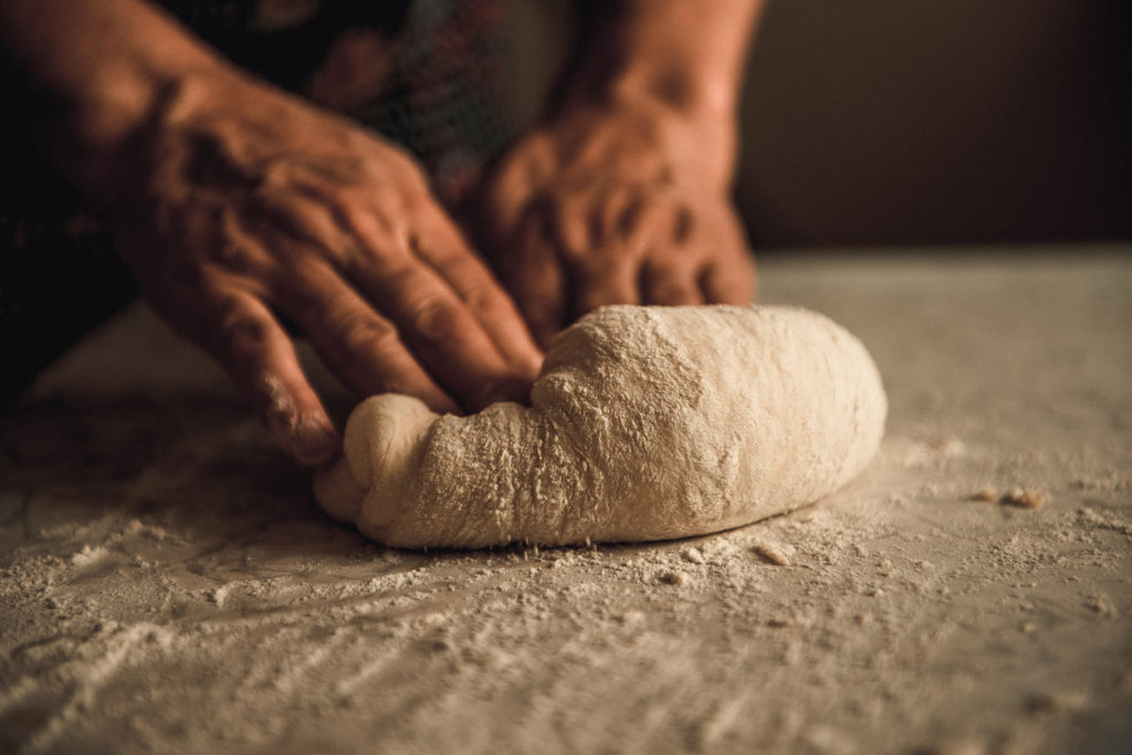 woman kneading bread