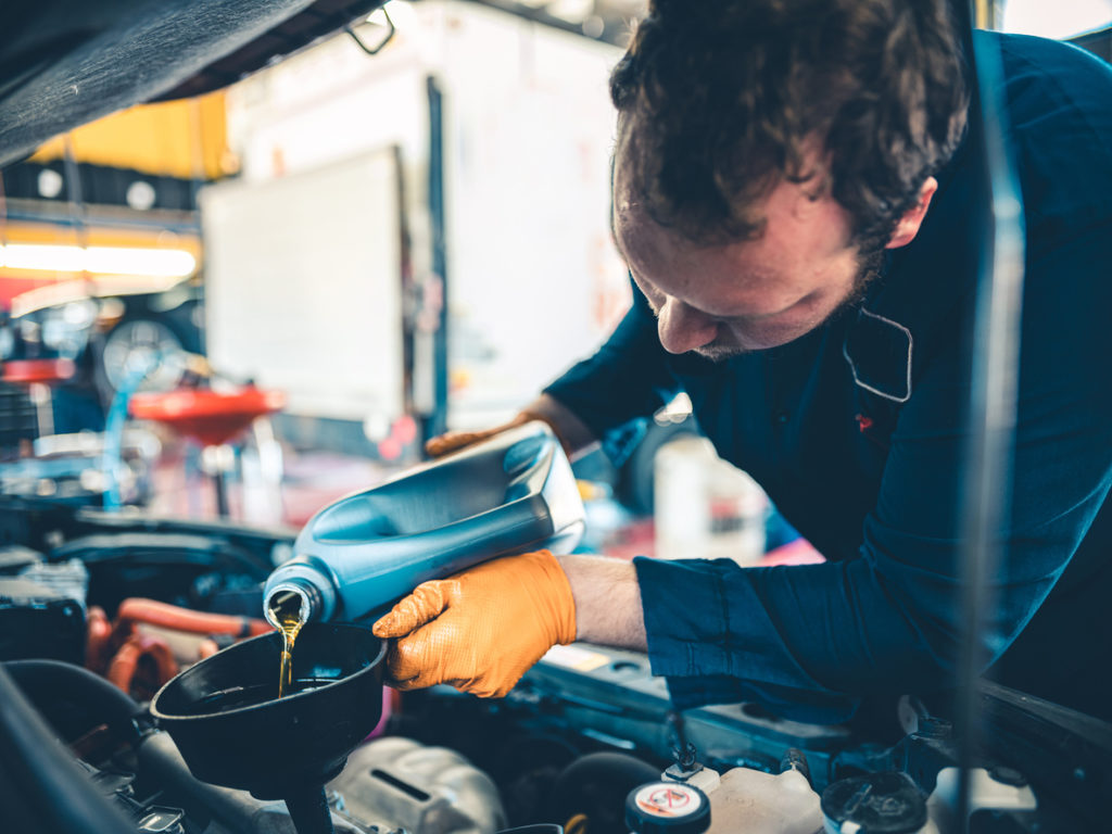 Technician performing an oil change