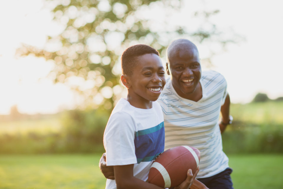 Father and son playing backyard football