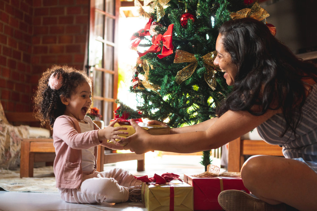 Parent giving her child a Christmas present