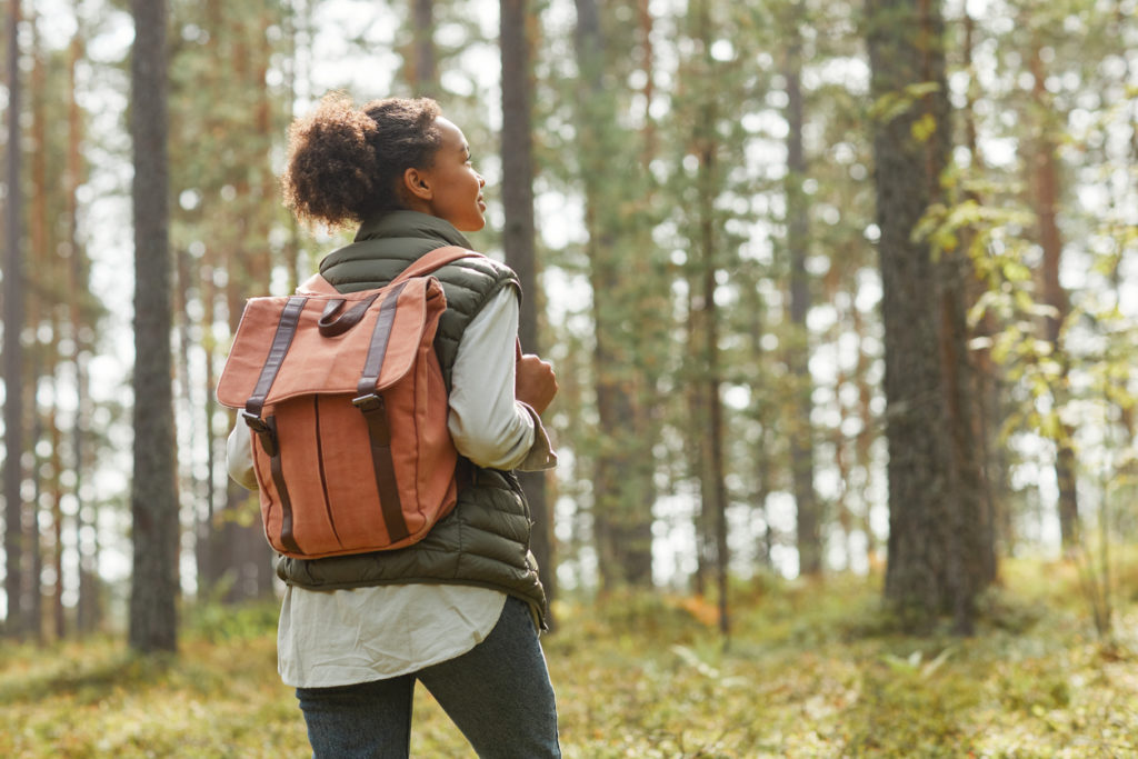 oung Woman with Backpack Outdoors