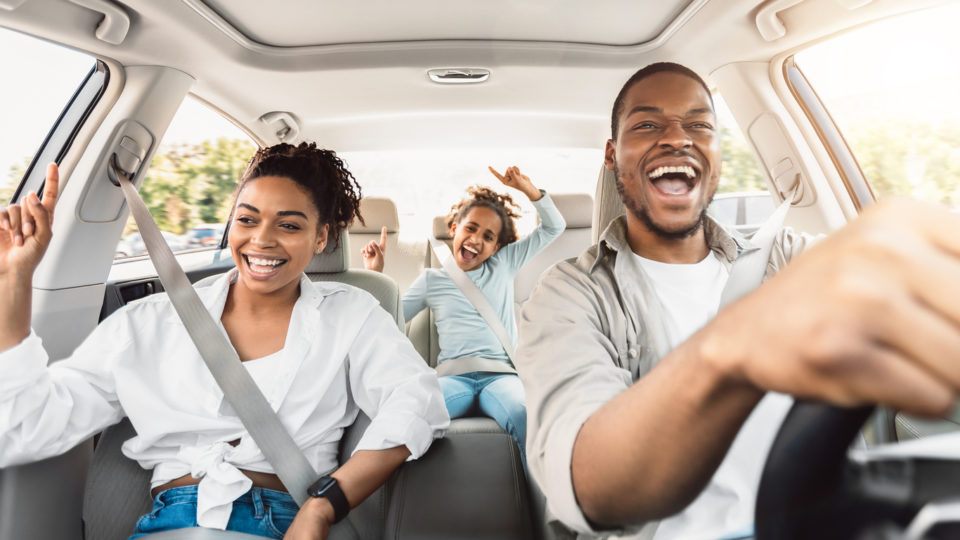 family enjoying summer road trip.