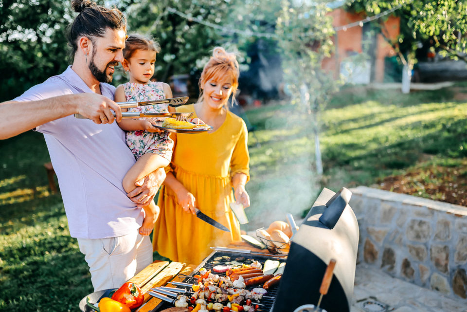 Father and daughter prepare a grilled meal together