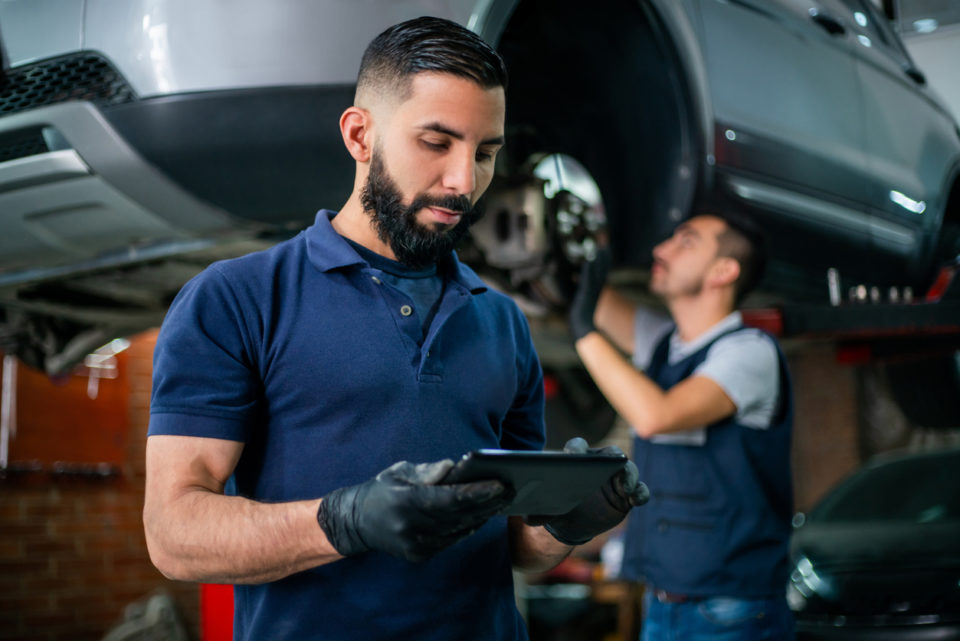 Supervisor at a car workshop checking tablet